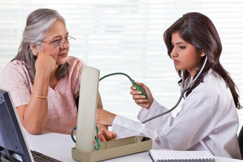 The doctor measures blood pressure in hypertension